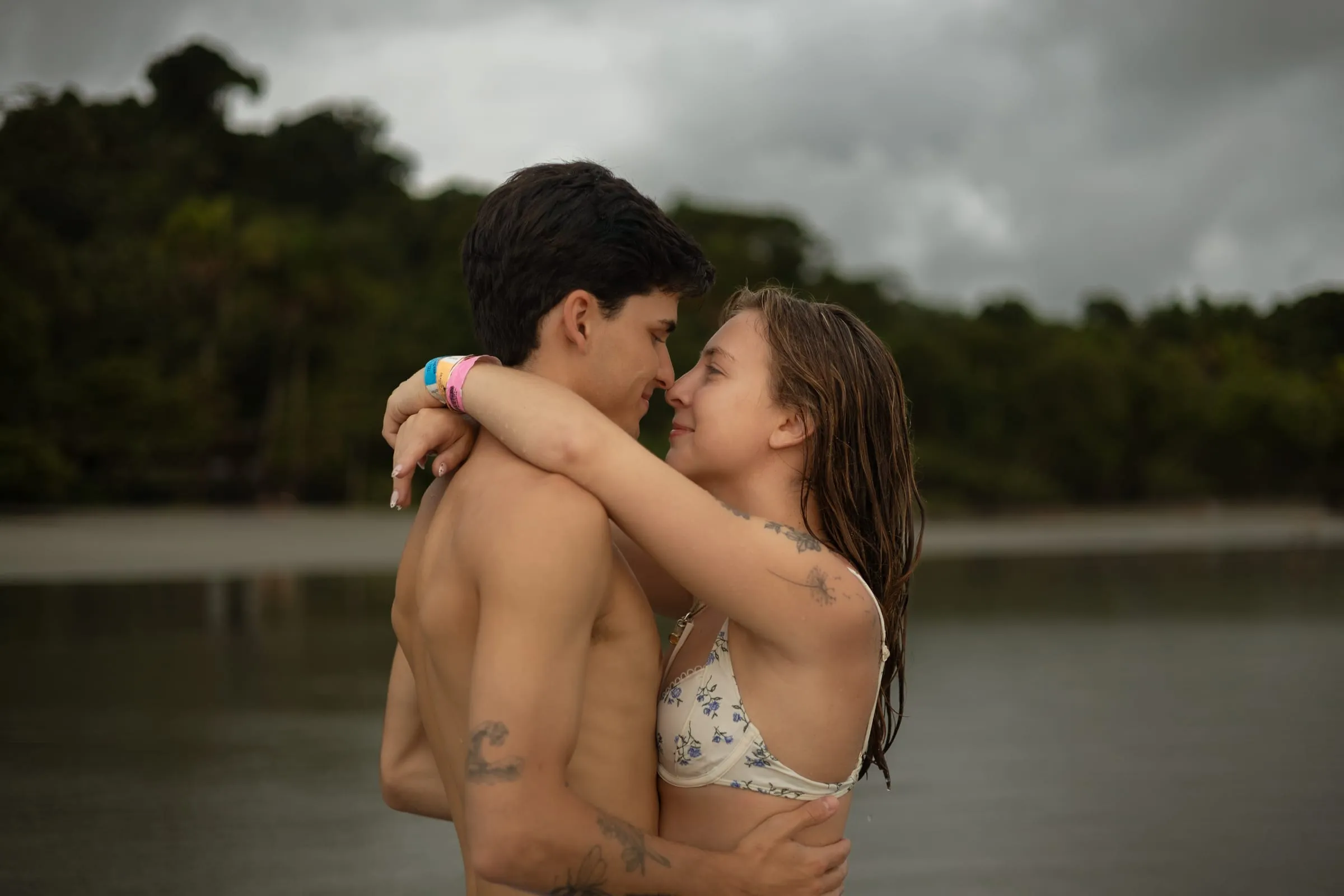 Couple face to face with jungle-covered hills behind
