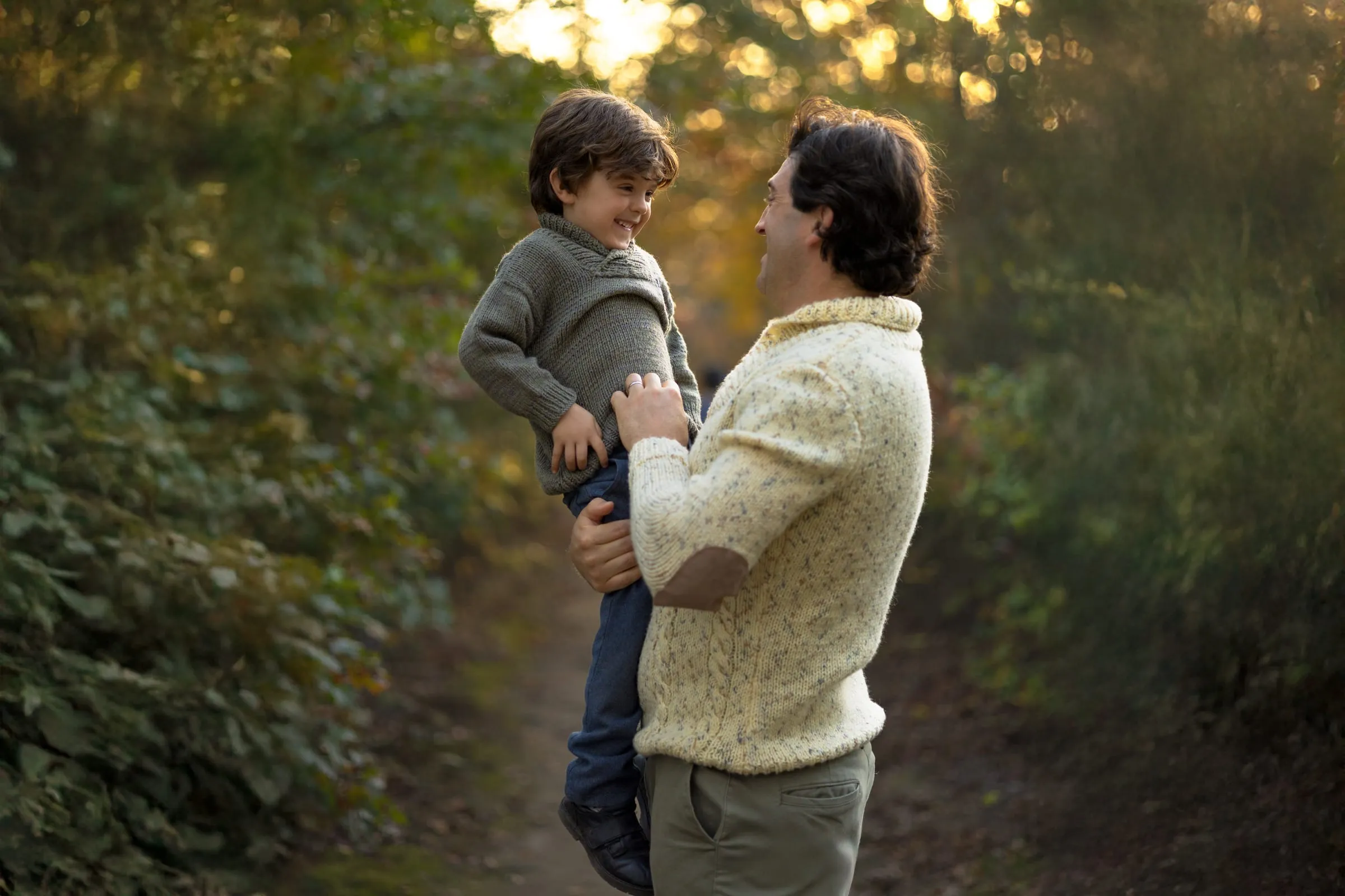 Dad playing with his son on a forest trail
